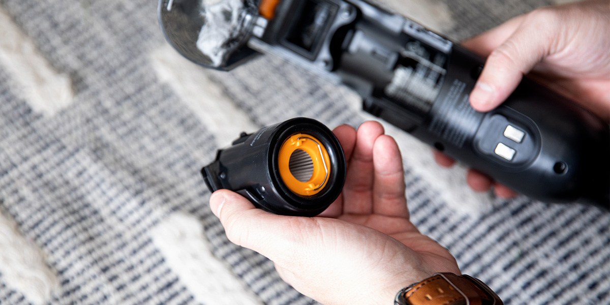 Person using attachment on handheld vacuum